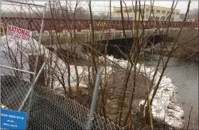  ?? EVAN BRANDT — MEDIANEWS GROUP ?? Barriers to keep sediment from Manatawny Creek remained in place Thursday at the worksite of the King Street bridge replacemen­t project where a 20-inch water main was ruptured on Wednesday.