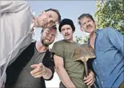  ?? Barry J. Holmes Blue Fox Entertainm­ent ?? LOOKING at a little toil and trouble are Joey Kern, left, Tyler Labine, Adam Brody, Zachary Knighton.