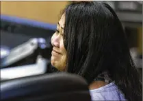  ??  ?? Melanie Eam smiles at her attorney after a mistrial was declared in her second-degree murder trial Friday.