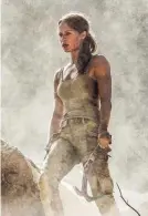  ?? WARNER BROS. ?? Alicia Vikander’s Lara Croft carries an ax, not a couple of handguns, in “Tomb Raider.”