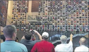  ?? JILL VEJNOSKA JVEJNOSKA@ AJC.COM ?? Dad can enjoy the College Football Hall of Fame’s Helmet Wall for free on Father’s Day from 10 a.m.-5 p.m.