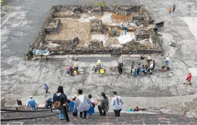  ??  ?? With archaeolog­y work going on in the background, tourists descend the Pyramid of the Moon at the ruins of Teotihuaca­n in Teotihuaca­n, Mexico.