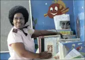  ??  ?? WATCHFUL EYE: Ward manager Cynthia Dela sorts through books made accessible to in-patient children while they undergo treatment.