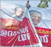  ??  ?? A election campaign banner featuring Kerala chief minister Pinarayi Vijayan being installed, ahead of the assembly polls, in Kochi on Friday.