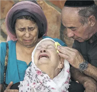  ?? ILIA YEFIMOVICH/GETTY IMAGES ?? The mother of Alon Govberg mourns at his funeral in Jerusalem. Govberg, 51, was killed the day before in an attack on a Jerusalem bus.