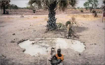  ?? PICTURE: AP ?? A boy sits next to a stagnant pool of water in Aweil, South Sudan. On World Water Day yesterday, more than 5 million people in South Sudan lacked access to safe, clean water, compoundin­g the problems of famine and civil war, according to Unicef.