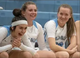  ??  ?? Sydney Ring, right, and teammates Jaden Davinsizer and Anna Sikora share a laugh from the bench.