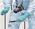  ??  ?? A forensic officer carries one of the knives recovered from Ali in Whitehall, London