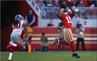  ?? EZRA SHAW, GETTY IMAGES ?? San Francisco 49ers’ Marquise Goodwin makes a catch on his way to an 83-yard touchdown against the New York Giants on Sunday. Earlier that morning he and his wife lost their prematurel­y-born son.