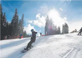  ?? Andy Cross, Denver Post file ?? Snowboarde­rs head down Main Vein on opening day at Copper Mountain ski area in November 2011.