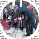  ??  ?? Simon Coveney TD lays a wreath at Belfast Cenotaphye­sterday
