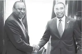  ??  ?? Jamaica’s Prime Minister Andrew Holness (right) meets with Kenya’s President Uhuru Kenyatta on June 8 ahead of Holness’ address, the following day, to leaders at the G7 Summit in Quebec, Canada.