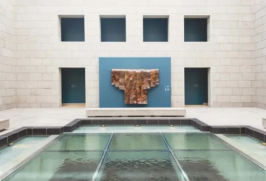  ??  ?? Images at far left: “Smoulder” consists of carved and fitted stones coming together to o er a feeling of warmth. Copper is inlayed, giving the illusion of the shimmer and glow of a dying campfire. Above: Michael’s “Lost Bridal Veil” installati­on on display at the National Gallery of Canada.