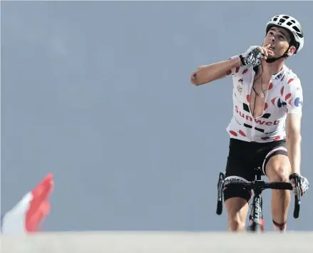  ?? PICTURE: AP ?? FIRST ONE HOME: France’s Warren Barguil, wearing the best climber’s dotted jersey celebrates as he crosses the finish line to win the eighteenth stage of the Tour de France cycling race from Briancon to the Izoard pass yesterday.