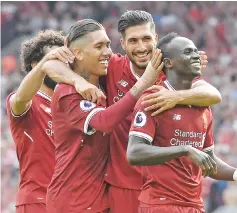  ??  ?? Liverpool’s Senegalese midfielder Sadio Mane (R) celebrates with teammates after scoring their second goal during the English Premier League football match between Liverpool and Arsenal at Anfield in Liverpool, north west England on August 27, 2017. -...