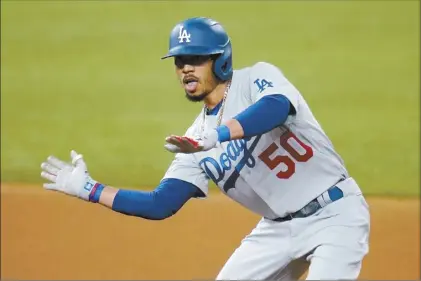  ?? AP photo ?? The Dodgers’ Mookie Betts gestures after his double during the fourth inning of Los Angeles’ 12-3 victory over the San Diego Padres in Game 3 of their NL Division Series on Thursday.