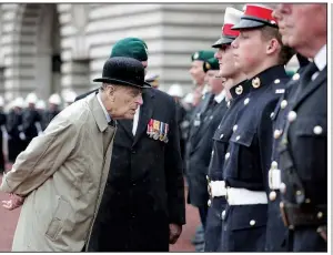  ?? AP/YUI MOK ?? Britain’s Prince Philip, in his role as captain general of the Royal Marines, talks to troops as he attends a parade on the forecourt of Buckingham Palace on Wednesday in central London.