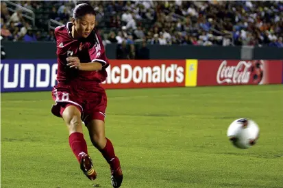  ??  ?? Former Chinese national team captain Zhang Ouying, shown in an internatio­nal match, has stepped away from the San Diego Soccer Club as she battles cancer.