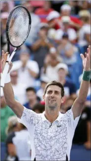  ?? JOHN MINCHILLO — THE ASSOCIATED PRESS ?? Novak Djokovic, of Serbia, celebrates after defeating Roger Federer of Switzerlan­d in the championsh­ip at the Western &amp; Southern Open tennis tournament, Sunday in Mason, Ohio.