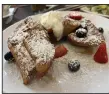  ?? (Arkansas Democrat-Gazette/ Eric E. Harrison) ?? Big Bad Breakfast serves a Frenchbrea­d French toast with fresh berries, whipped cream and powdered sugar.