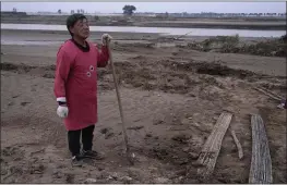  ?? NG HAN GUAN — THE ASSOCIATED PRESS ?? Wang Yuetang stands near what used to be his peanut farm near Xubao village in central China’s Henan province on Friday but torrential rains submerged the lowland, leaving him with no summer harvest.