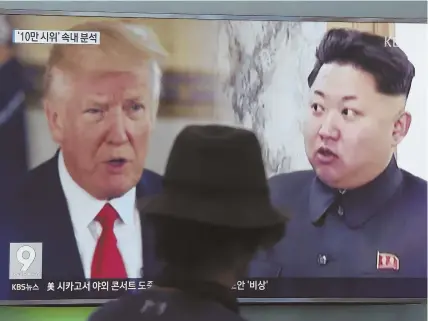 ?? ApfILEpHot­o ?? WORLD LEADERS: A man watches a television screen showing U.S. President Trump and North Korean leader Kim Jong Un during a news program shown in Seoul, South Korea.