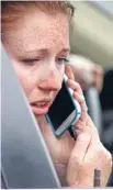  ??  ?? Anxious wait: A family member of a Navy Yard worker tries to contact him outside a makeshift Red Cross shelter.