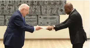  ?? (Mark Neyman/GPO) ?? CALIXTE BATOSSIE MADJOULBA of Togo presents his credential­s to President Reuven Rivlin at the President’s Residence in the capital yesterday.