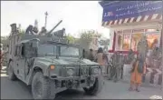  ?? AP ?? Taliban fighters stand guard at a checkpoint in Kunduz city in northern Afghanista­n