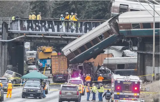  ?? Picture: AFP ?? Emergency crews work at the scene of an Amtrak train derailment at DuPont, Washington state.