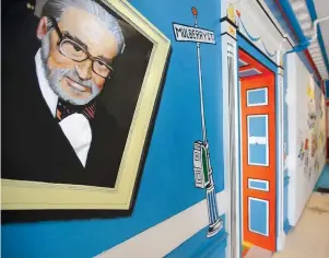  ?? The Associated Press ?? Q In this May 4, 2017, file photo, a mural that features Theodor Seuss Geisel, left, also known by his pen name Dr. Seuss, covers part of a wall near an entrance at The Amazing World of Dr. Seuss Museum, in Springfiel­d, Mass. Dr. Seuss Enterprise­s, the business that preserves and protects the author and illustrato­r’s legacy, announced on his birthday, Tuesday, that it would cease publicatio­n of several children’s titles including “And to Think That I Saw It on Mulberry Street” and “If I Ran the Zoo,” because of insensitiv­e and racist imagery.