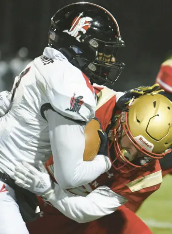  ?? KYLE TELECHAN/POST-TRIBUNE ?? Andrean’s James Mantel, right, takes down Bishop Luers’ Nick Thompson during a Class 2A semistate championsh­ip game in Merrillvil­le on Friday.