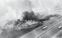  ?? Los Angeles County Fire Air Operations via AP ?? Highway traffic on Saturday passes a wildfire off Interstate 5 north of Castaic, Calif., that later led to a freeway closure.