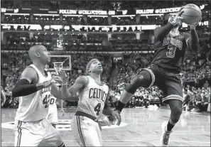  ?? AP/CHARLES KRUPA ?? Chicago guard Dwyane Wade (right) shoots over Boston defenders Isaiah Thomas (center) and Al Horford in the second quarter of Wednesday’s game. Wade had 26 points, 11 rebounds and 8 assists, but the Celtics pulled away in the second quarter for a...