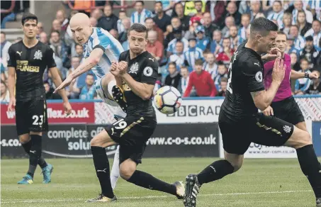  ??  ?? Huddersfie­ld midfielder Aaron Mooy hits Huddersfie­ld’s winner at home to Newcastle United yesterday.