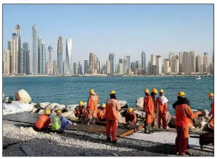  ?? AP ?? Laborers work at a constructi­on site in Dubai, United Arab Emirates, in this 2015 file photo. A report by the Washington-based Center for Advanced Defense Studies says Dubai’s secretive and booming real-estate market is used to hide assets.