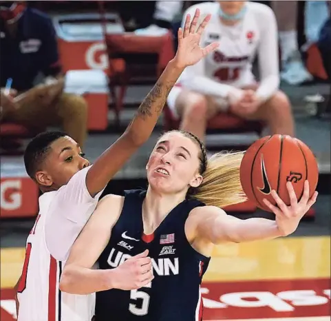  ?? Kathy Willens / Associated Press ?? St. John’s guard Kadaja Bailey (30) fouls UConn guard Paige Bueckers during the second quarter of Wednesday’s game in New York.