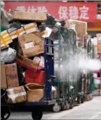  ?? WANG PEN ?? Parcels are disinfecte­d at a delivery ce autonomous region, on Nov 11.