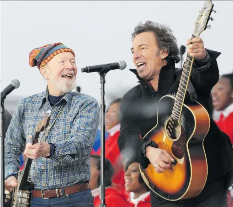  ?? MANDEL NGAN/GETTY IMAGES ?? Pete Seeger, left, performs with Bruce Springstee­n at the 2009 We Are One inaugural celebratio­n for then-president Barack Obama in Washington, D.C. Seeger, who died in 2014 and is now the subject of a children’s book, was a leading voice for various social issues.