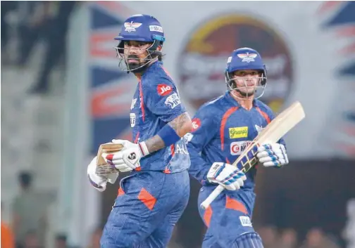  ?? Associated Press ?? ↑
Lucknow Super Giants’ captain K.L Rahul (left) and Quinton de Kock run between the wickets in Lucknow, India, on Friday.