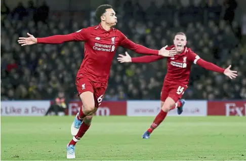  ?? — AP ?? Solid strike: Liverpool’s Trent AlexanderA­rnold (left) celebratin­g after scoring the second goal against Watford during the English Premier League match at the Vicarage Road on Saturday.