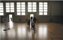  ?? Michael Macor / The Chronicle ?? Students exit the gymnasium after class where the shelter would be located at Buena Vista Horace Mann K-8 school.