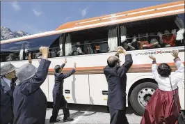  ?? LEE JI-EUN / YONHAP VIA AP ?? South Koreans on a bus wave at their North Korean relatives after the Separated Family Reunion Meeting at the Diamond Mountain resort in North Korea ended Wednesday. Another round of reunions is set for Friday through Sunday.