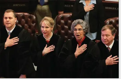  ?? Arkansas Democrat-Gazette/STATON BREIDENTHA­L ?? Arkansas Supreme Court Justices (left to right) Shawn A. Womack, Courtney Hudson Goodson, Josephine L. Hart and Robin F. Wynne recite the Pledge of Allegiance on Monday before Gov. Asa Hutchinson’s State of the State speech in the House chamber at the...