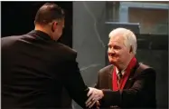  ?? AP FILE PHOTO BY ED ZURGA ?? In this 2010 photo, former Kansas State basketball coach Tex Winter, right, shakes hands with Kansas State coach Frank Martin during the former’s induction into the National Collegiate Basketball Hall of Fame in Kansas City, Mo.