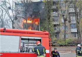  ?? ?? EMERGENCY: Fire crews deal with a missile strike in Kyiv amid reports of Russian armoury exploding over the border in Poland.