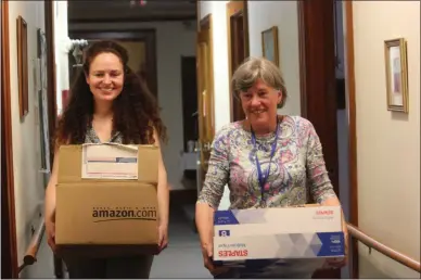  ?? PHOTOS BY CHARLES PRITCHARD — ONEIDA DAILY DISPATCH ?? Madison County Historical Society Executive Director Sydney Loftus, left, and Eileen Kinsella move boxes of documents out of the Hazel Carpenter Adult Home to go to the Madison County Historical Society on Wednesday, Aug. 7.