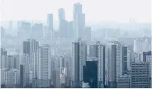  ?? Yonhap ?? Apartment buildings are seen from central Seoul’s Mount Nam, Sunday.