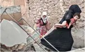  ??  ?? Iraqi civilians flee through a destroyed alley as Iraqi Special Forces continue their advance against Islamic State militants in the Old City of Mosul in Iraq on Sunday