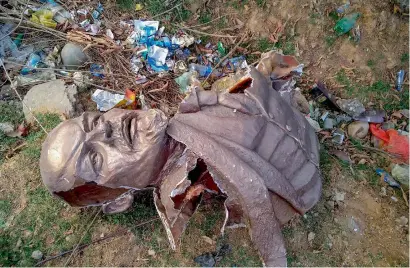  ??  ?? Remains of the five-feet-tall statue of Lenin which was demolished by a pay-loader at Belonia in South Tripura district on Monday afternoon and was thrown at the nearby jungle. The statue, made of fibre glass, was inaugurate­d by CPM leader Prakash Karat. —